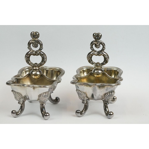 200 - A set of four Italian silver boat shaped salt cellars, on scroll feet.