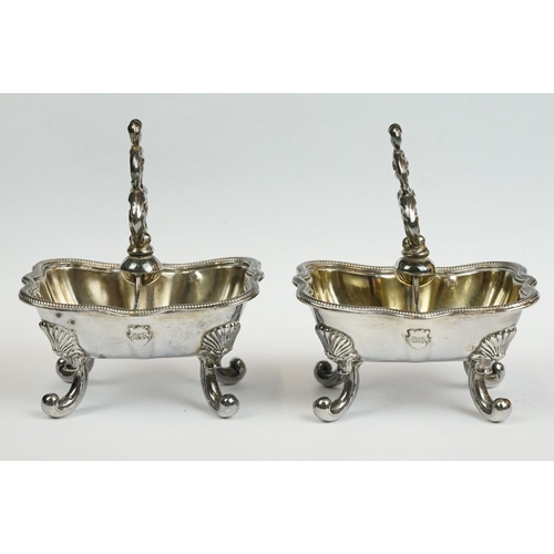 200 - A set of four Italian silver boat shaped salt cellars, on scroll feet.