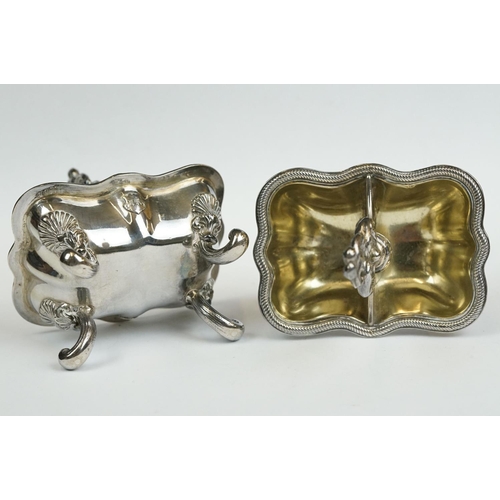 200 - A set of four Italian silver boat shaped salt cellars, on scroll feet.