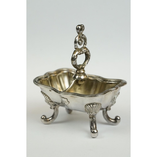 200 - A set of four Italian silver boat shaped salt cellars, on scroll feet.