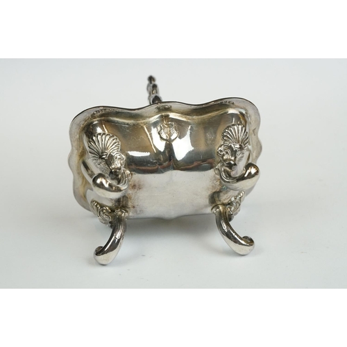 200 - A set of four Italian silver boat shaped salt cellars, on scroll feet.