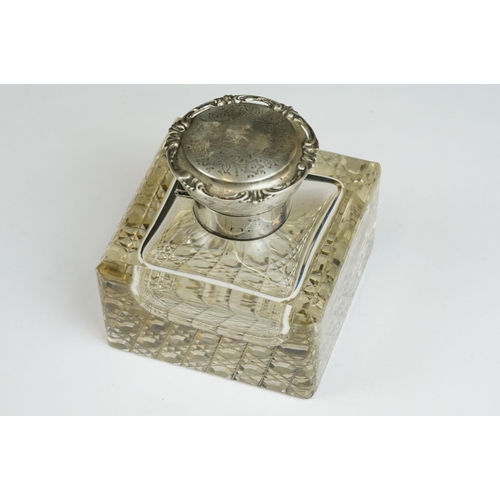 201A - An early 20th century cut glass inkwell with sterling silver top together with a sterling silver toa... 