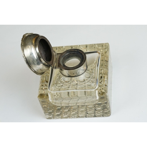 201A - An early 20th century cut glass inkwell with sterling silver top together with a sterling silver toa... 