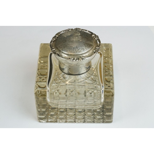 201A - An early 20th century cut glass inkwell with sterling silver top together with a sterling silver toa... 