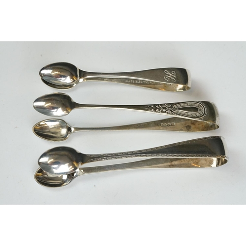 208 - Three silver sugar tongs, a millennium cheese scoop and other spoons