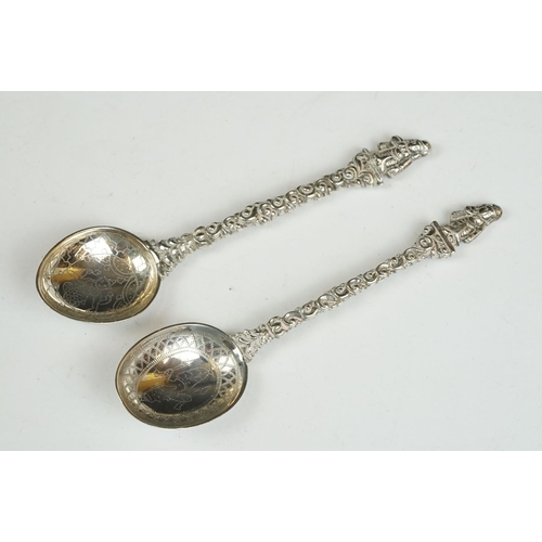 208 - Three silver sugar tongs, a millennium cheese scoop and other spoons