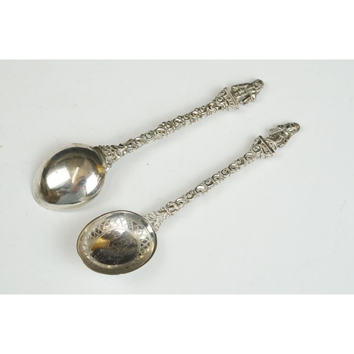 208 - Three silver sugar tongs, a millennium cheese scoop and other spoons