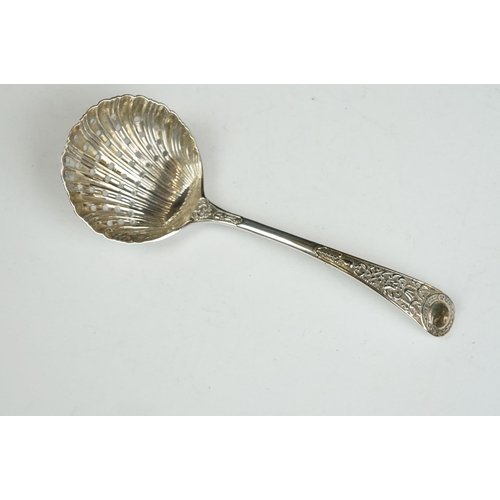 208 - Three silver sugar tongs, a millennium cheese scoop and other spoons