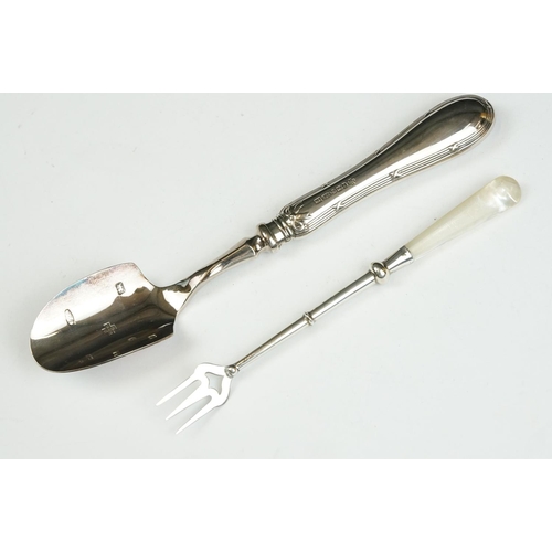 208 - Three silver sugar tongs, a millennium cheese scoop and other spoons