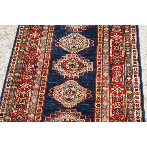 585 - Eastern Red and Blue Ground Wool Runner Rug decorated with thirteen guls within a deep border, appro... 