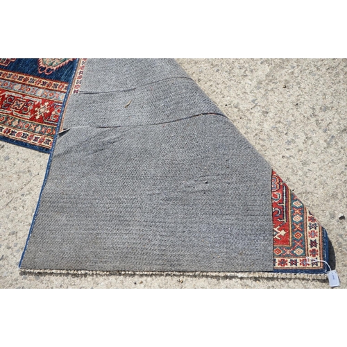 585 - Eastern Red and Blue Ground Wool Runner Rug decorated with thirteen guls within a deep border, appro... 