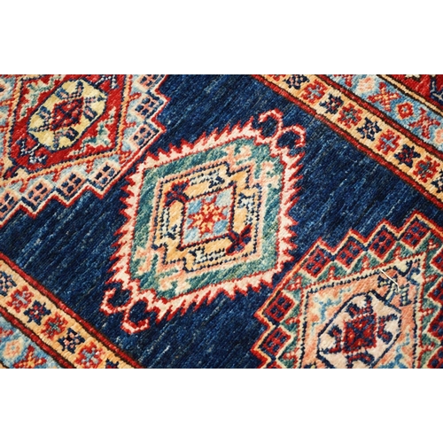 585 - Eastern Red and Blue Ground Wool Runner Rug decorated with thirteen guls within a deep border, appro... 