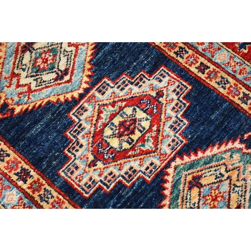 585 - Eastern Red and Blue Ground Wool Runner Rug decorated with thirteen guls within a deep border, appro... 