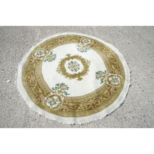 597 - Cream and Green Ground Circular Rug with floral pattern, approx. 185cm diameter