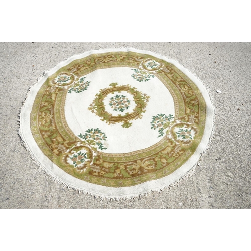 597 - Cream and Green Ground Circular Rug with floral pattern, approx. 185cm diameter