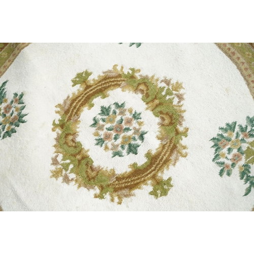 597 - Cream and Green Ground Circular Rug with floral pattern, approx. 185cm diameter