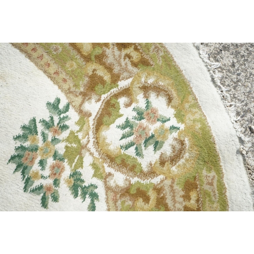 597 - Cream and Green Ground Circular Rug with floral pattern, approx. 185cm diameter