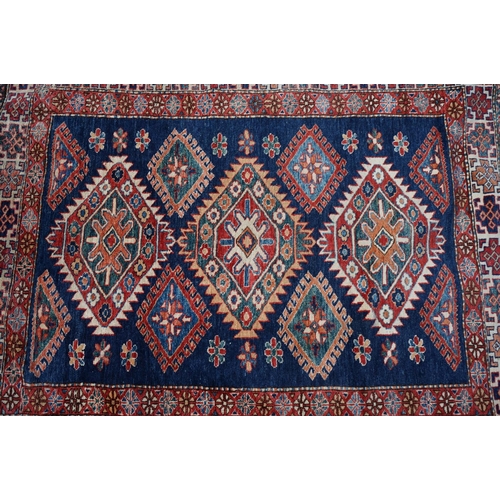 598 - Eastern Red and Blue Ground Wool Rug decorated with six guls within a deep border, approx. 151cm x 1... 