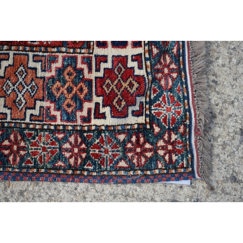 598 - Eastern Red and Blue Ground Wool Rug decorated with six guls within a deep border, approx. 151cm x 1... 