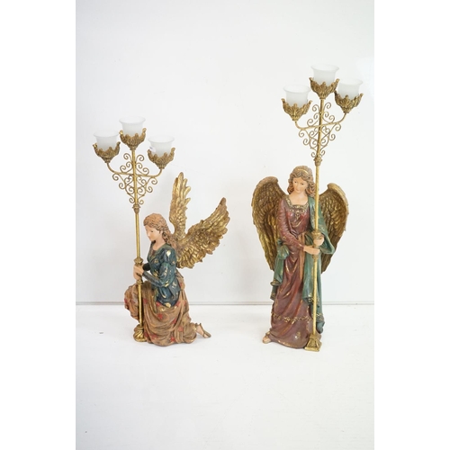 157 - Two composite resin figures tea light holders in the form of angels.