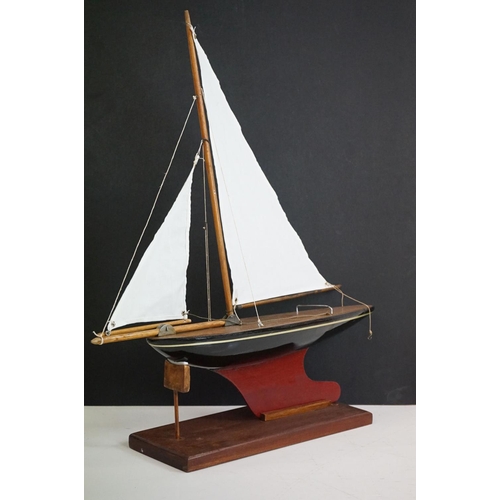 158 - A vintage wooden pond yacht complete with stand.