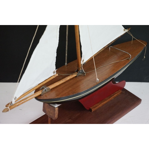 158 - A vintage wooden pond yacht complete with stand.