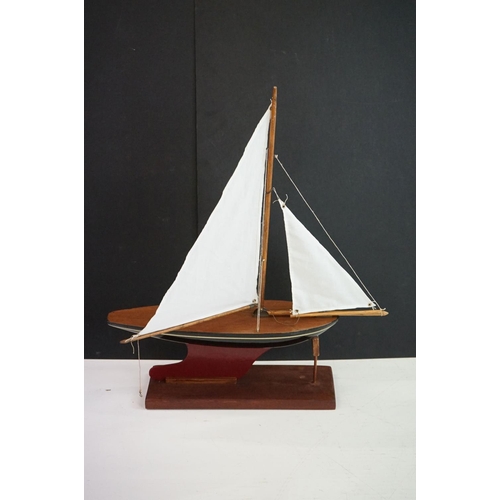 158 - A vintage wooden pond yacht complete with stand.