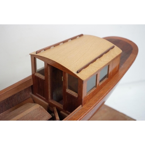 161 - A kit built wooden model steam boat together with a box of spare parts.