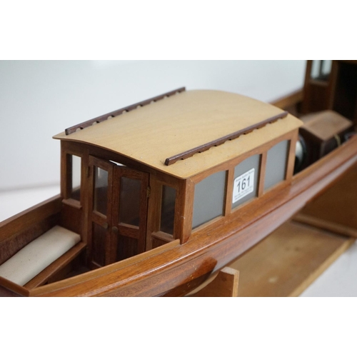 161 - A kit built wooden model steam boat together with a box of spare parts.