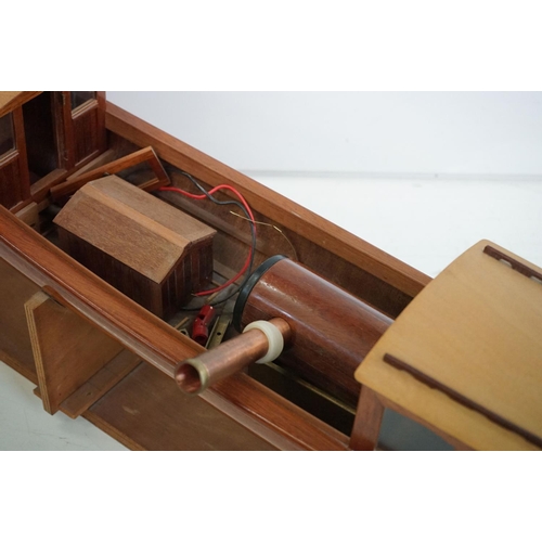 161 - A kit built wooden model steam boat together with a box of spare parts.