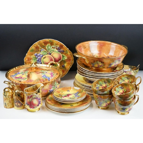 51 - Baroness china dinner service featuring painted peach and grape motifs and gilt rims. Signed A Mello... 