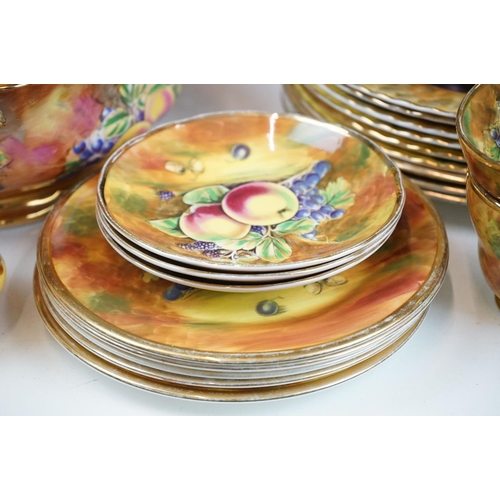 51 - Baroness china dinner service featuring painted peach and grape motifs and gilt rims. Signed A Mello... 