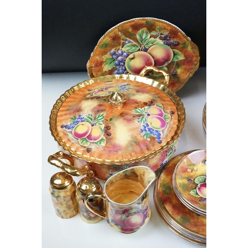 51 - Baroness china dinner service featuring painted peach and grape motifs and gilt rims. Signed A Mello... 