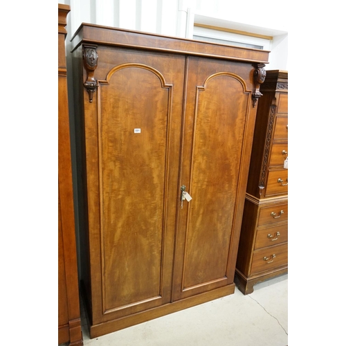 591 - Victorian Mahogany Double Wardrobe, the two panel doors opening to a hanging space with rail and peg... 