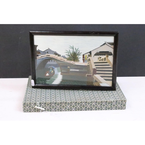 438 - A Chinese framed and glazed double sided silk picture of a boat on canal in gift box.