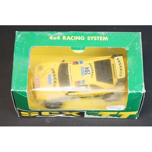 283 - Four boxed / cased SCX slot cars to include 2 x SCX TT 4x4 Racing System (73020 Peugeot 405 