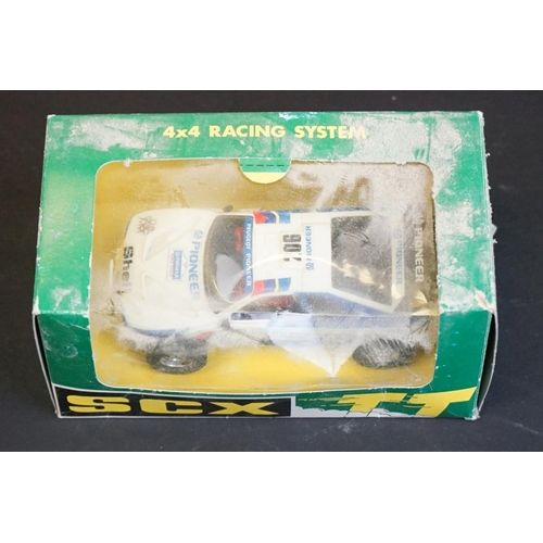 283 - Four boxed / cased SCX slot cars to include 2 x SCX TT 4x4 Racing System (73020 Peugeot 405 