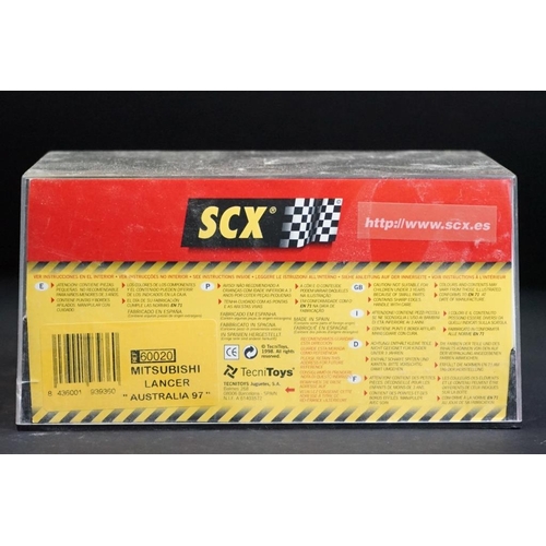 284 - Six cased SCX slot cars to include 60800 Subaru Impreza WRC, 60200 Chevrolet Nascar, 60130 Seat Ibiz... 