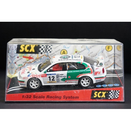 284 - Six cased SCX slot cars to include 60800 Subaru Impreza WRC, 60200 Chevrolet Nascar, 60130 Seat Ibiz... 