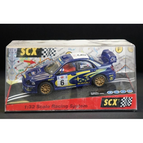 284 - Six cased SCX slot cars to include 60800 Subaru Impreza WRC, 60200 Chevrolet Nascar, 60130 Seat Ibiz... 