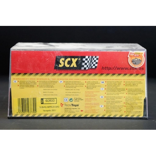 284 - Six cased SCX slot cars to include 60800 Subaru Impreza WRC, 60200 Chevrolet Nascar, 60130 Seat Ibiz... 