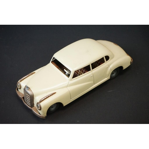 1254A - Two boxed tin plate models to include JNF M300 Nr 67F Friction Mercedes in cream and Arnold Mercedes... 