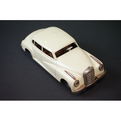 1254A - Two boxed tin plate models to include JNF M300 Nr 67F Friction Mercedes in cream and Arnold Mercedes... 