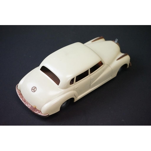 1254A - Two boxed tin plate models to include JNF M300 Nr 67F Friction Mercedes in cream and Arnold Mercedes... 