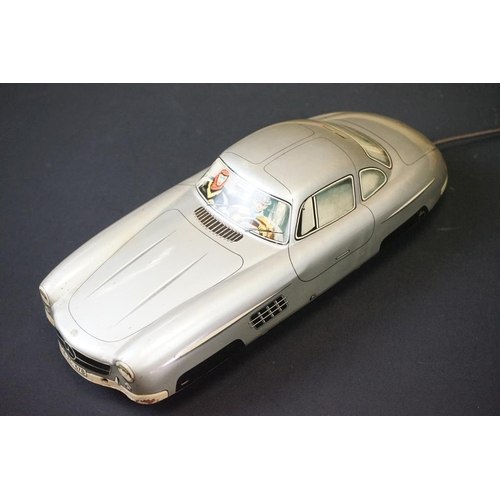 1254A - Two boxed tin plate models to include JNF M300 Nr 67F Friction Mercedes in cream and Arnold Mercedes... 