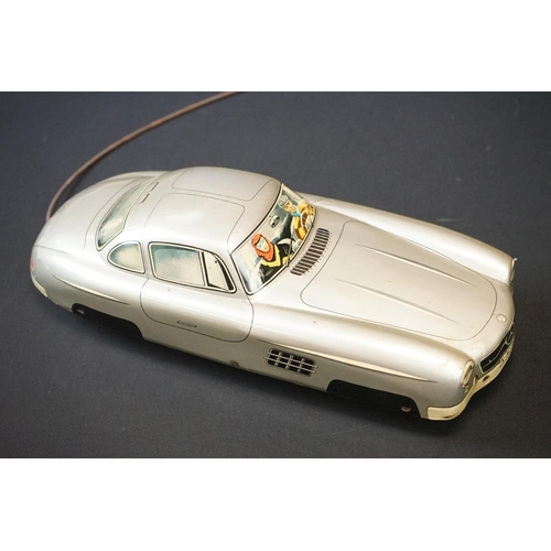 1254A - Two boxed tin plate models to include JNF M300 Nr 67F Friction Mercedes in cream and Arnold Mercedes... 