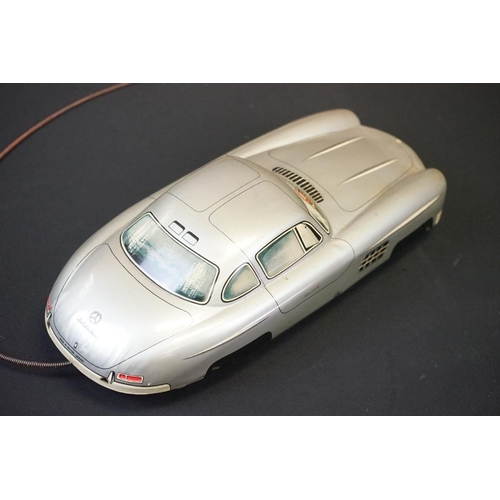 1254A - Two boxed tin plate models to include JNF M300 Nr 67F Friction Mercedes in cream and Arnold Mercedes... 