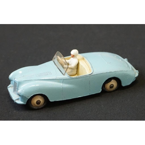 1257 - Seven mid 20th C Dinky play worn diecast models to include Triumph TR2 & Austin Devon plus a group o... 