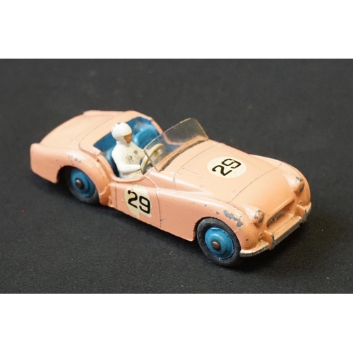 1257 - Seven mid 20th C Dinky play worn diecast models to include Triumph TR2 & Austin Devon plus a group o... 