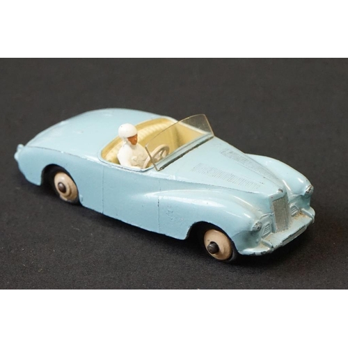 1257 - Seven mid 20th C Dinky play worn diecast models to include Triumph TR2 & Austin Devon plus a group o... 